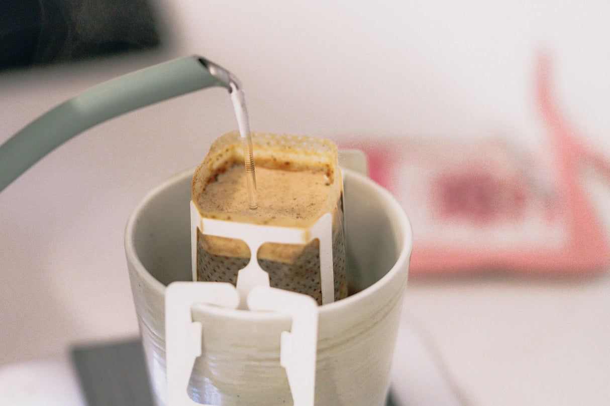 Coffee drip bag containing Wilder Lazo Tiki Punch, Colombia, being brewed
