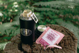 Coffee drip bag containing Wilder Lazo Tiki Punch, Colombia, being brewed in a forest