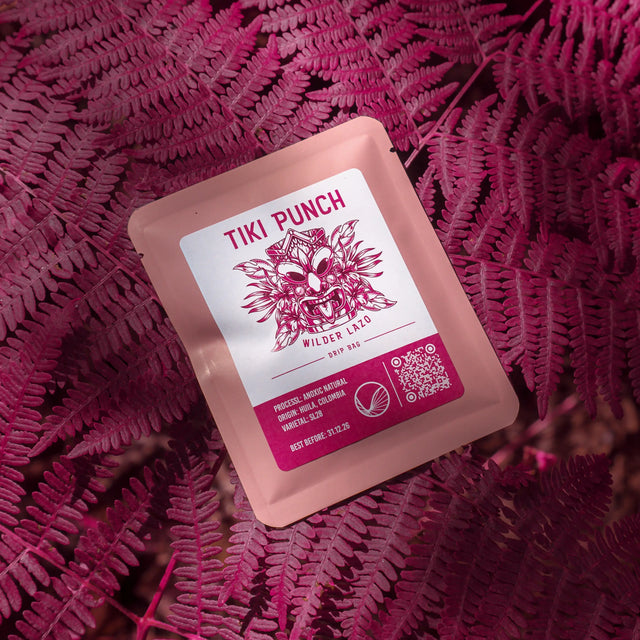 Coffee drip bag containing Wilder Lazo Tiki Punch, Colombia, on a pink background