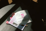 Dramatically lit ICON subscription coffee packaging on a coffee table.
