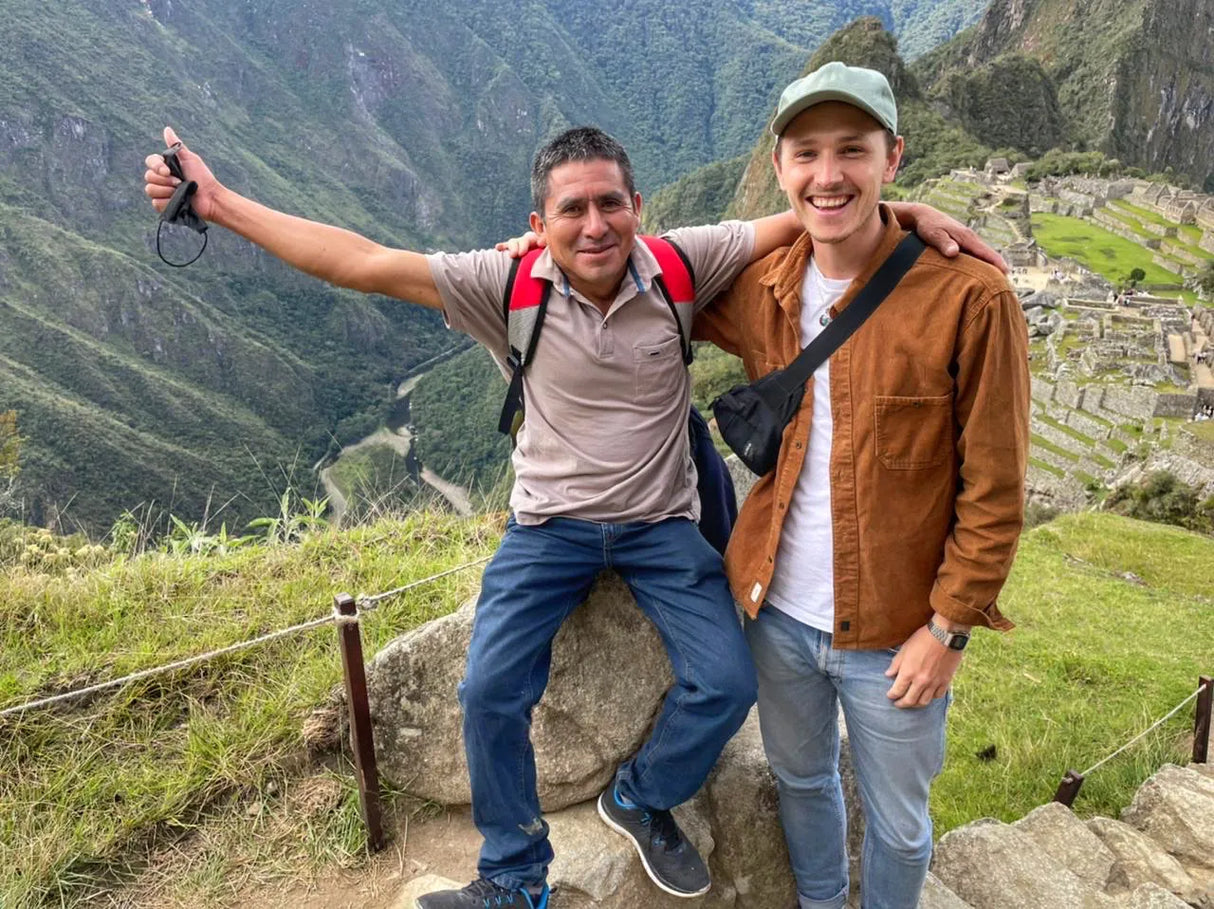 Marcelino Chinguel and Simon Brown of Chacra Coffee posing in the Andean mountains near some ancient ruins.