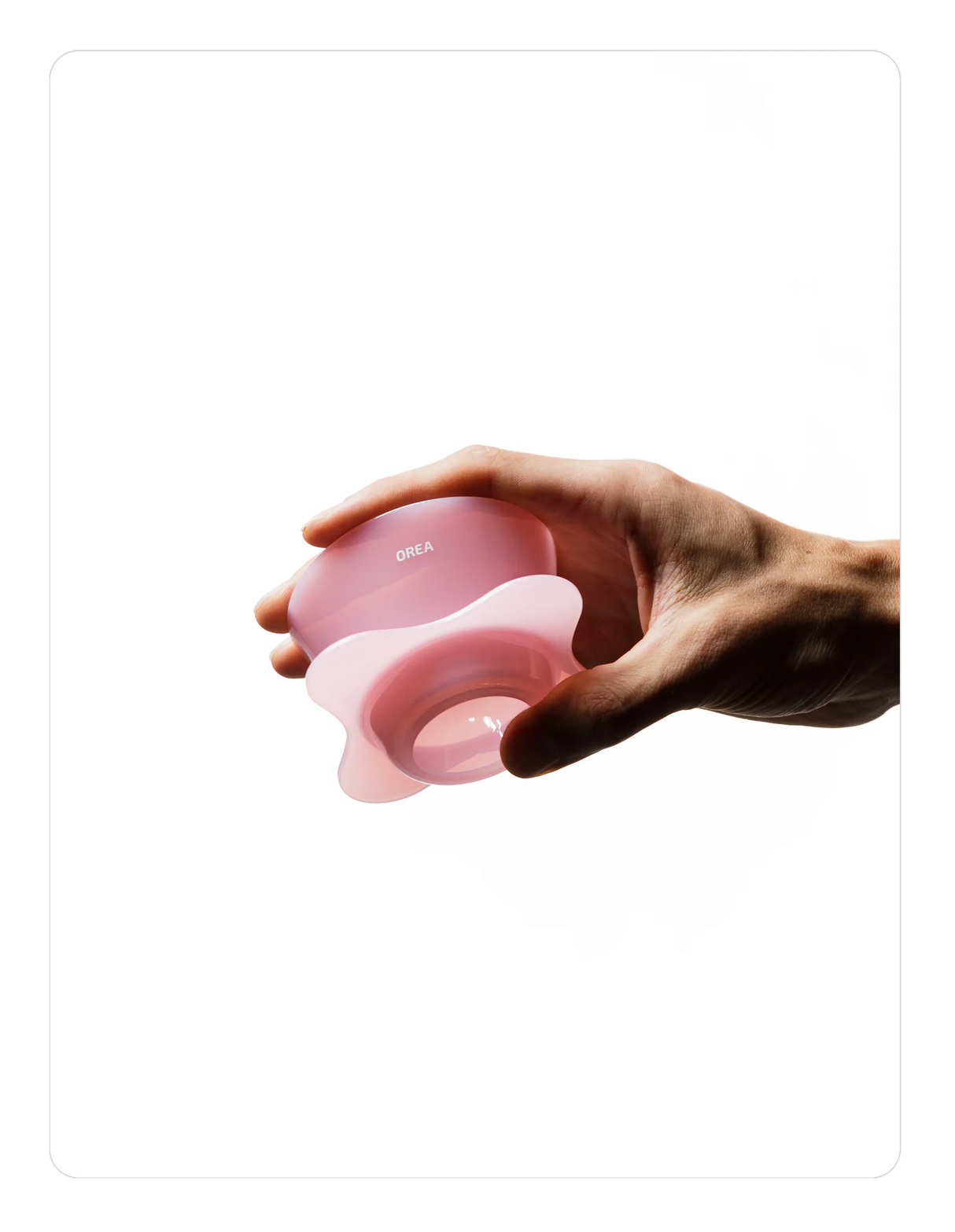 Hand holding a Creamy pink OREA 01 brewer on a white background