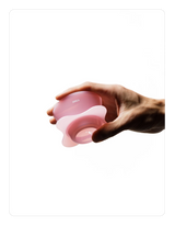 Hand holding a Creamy pink OREA 01 brewer on a white background