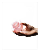 Hand holding a Creamy pink OREA 01 brewer against a white background
